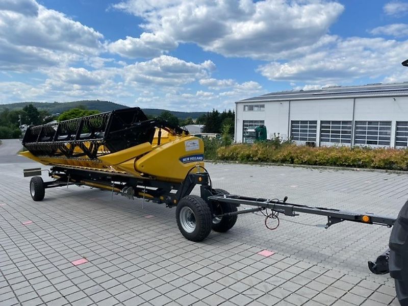 New Holland CX 5.80 inkl. 6,10m Varifeed & Wagen